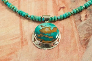 The Matrix of this Genuine Royston Turquoise Stone is outstanding! Genuine Royston Turquoise set in Sterling Silver Pendant on a Beautiful Necklace featuring Genuine Royston Turquoise Beads. Penshell Heishi Accents. Sterling Silver Beads and Clasp. Created by Navajo Artist Phillip Sanchez. The Royston Turquoise Mine is located in Nye County, Nevada.